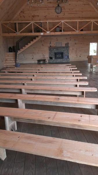 Our rustic barn venue features beautiful benches and a lovely fire place!