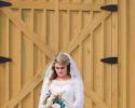 Featured we have a beautiful bride posing with a stunning floral bouquet! 