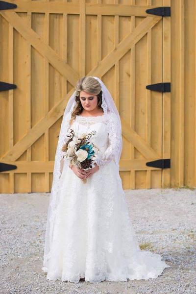 Featured we have a beautiful bride posing with a stunning floral bouquet! 